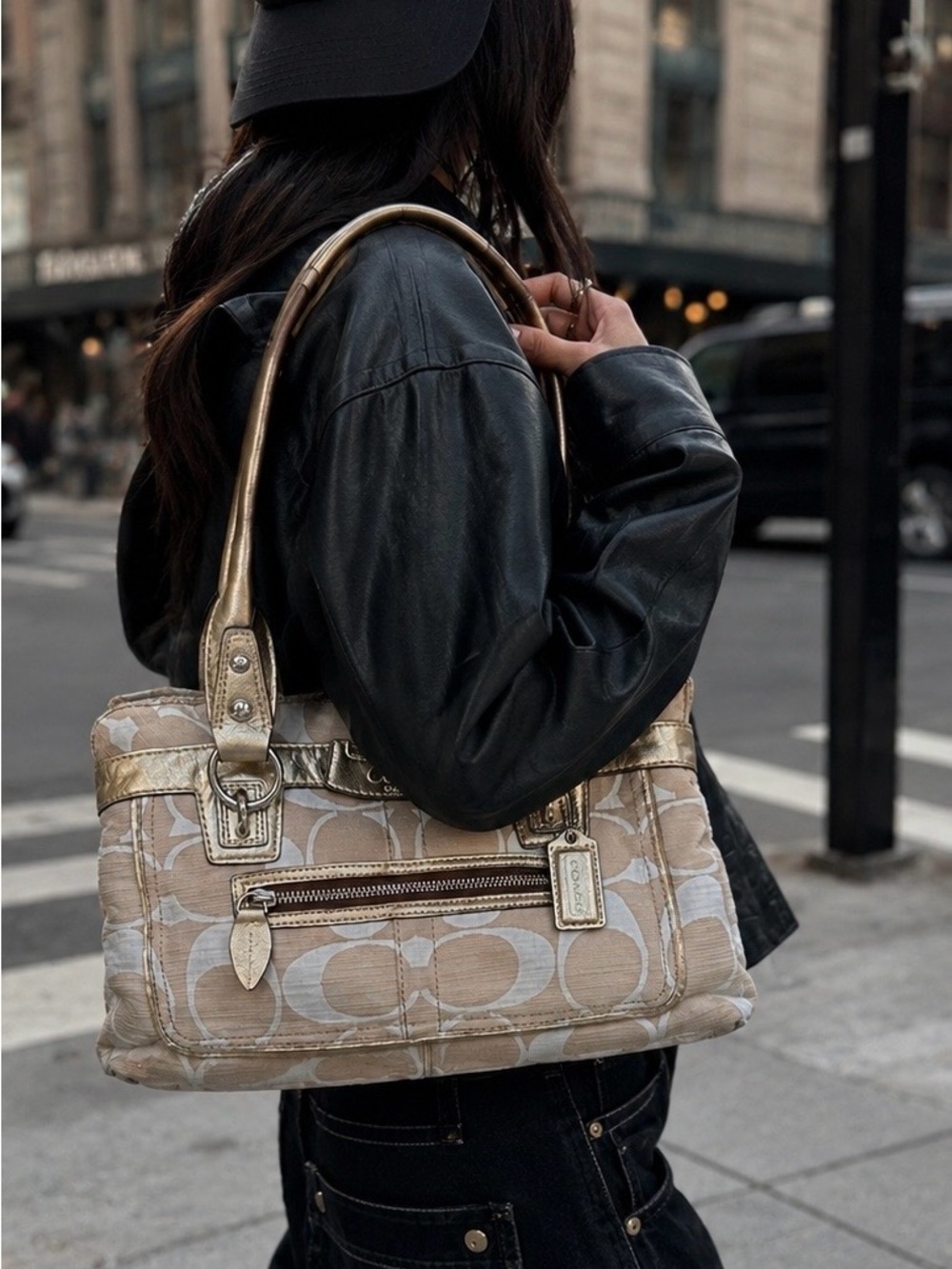 Coach Penelope Signature satchel bag with metallic gold leather trim.